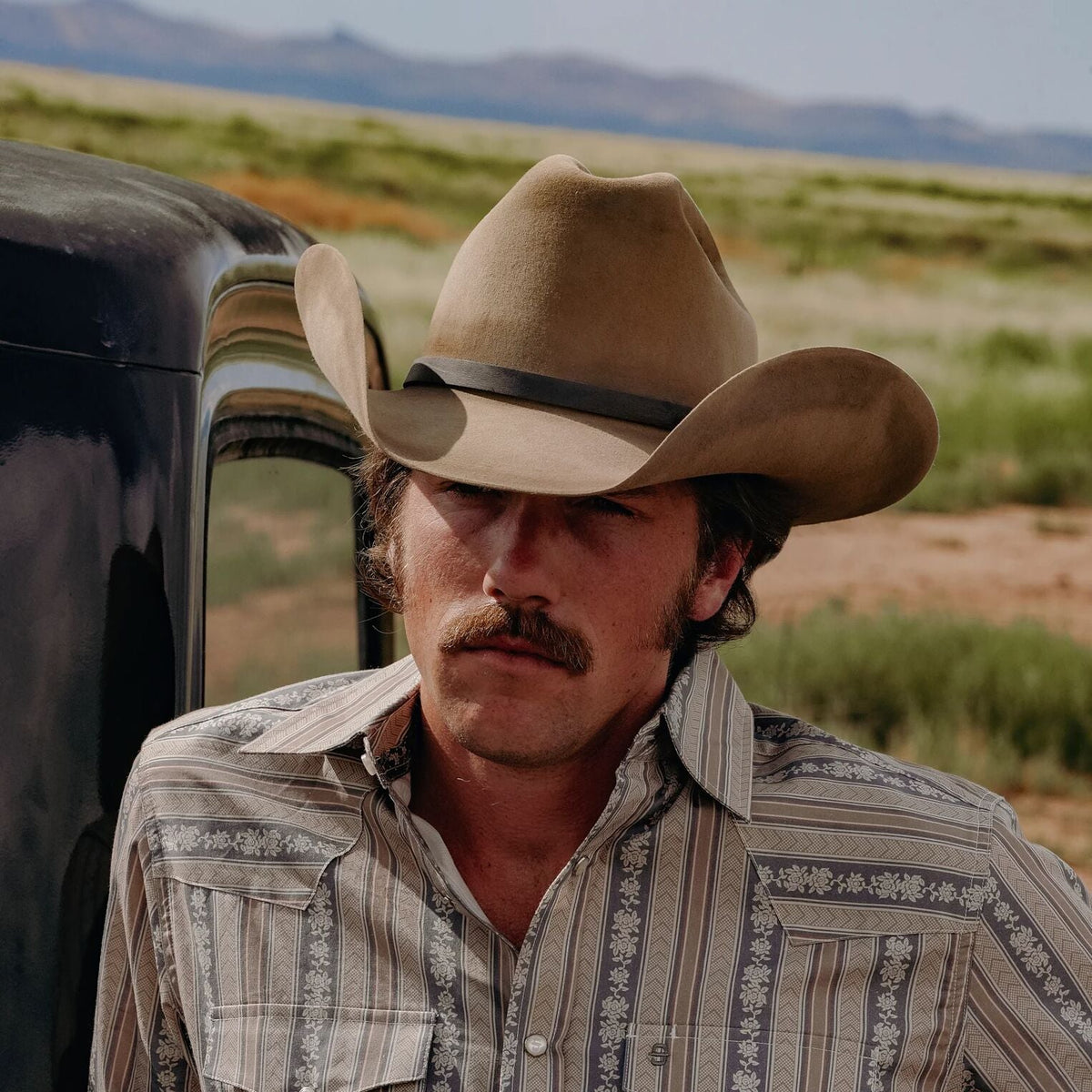 Cowboy wearing Stetson Boss of the Plains distressed brown felt hat